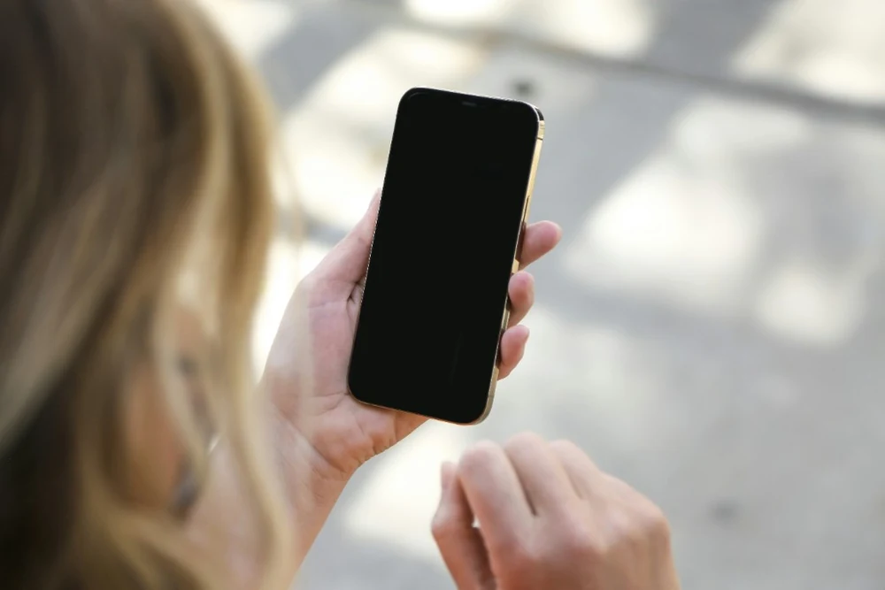 Person holding a phone, waiting for support