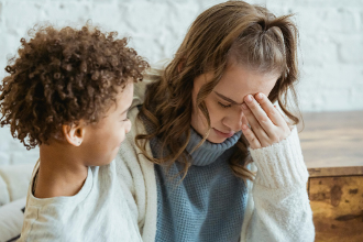 A mother and child sitting together during a difficult moment